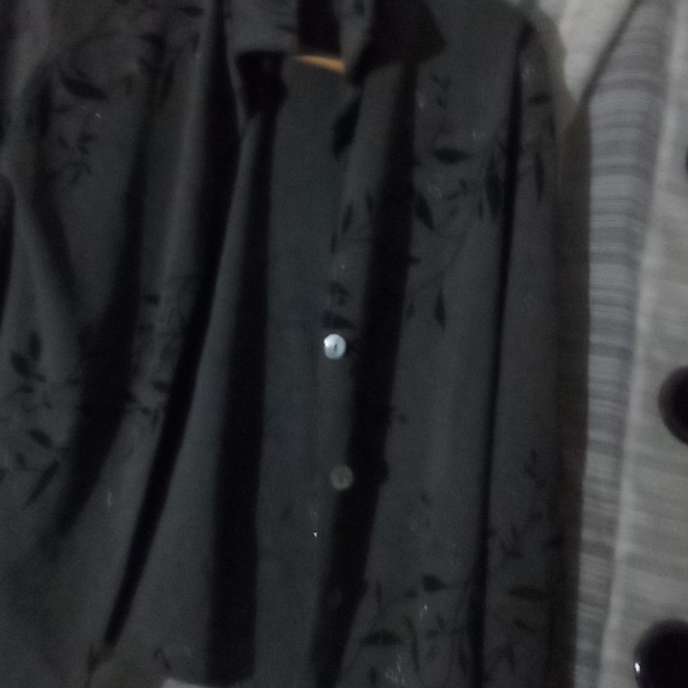 A block a gray black and silver dress with two splits to the side and a overcoat